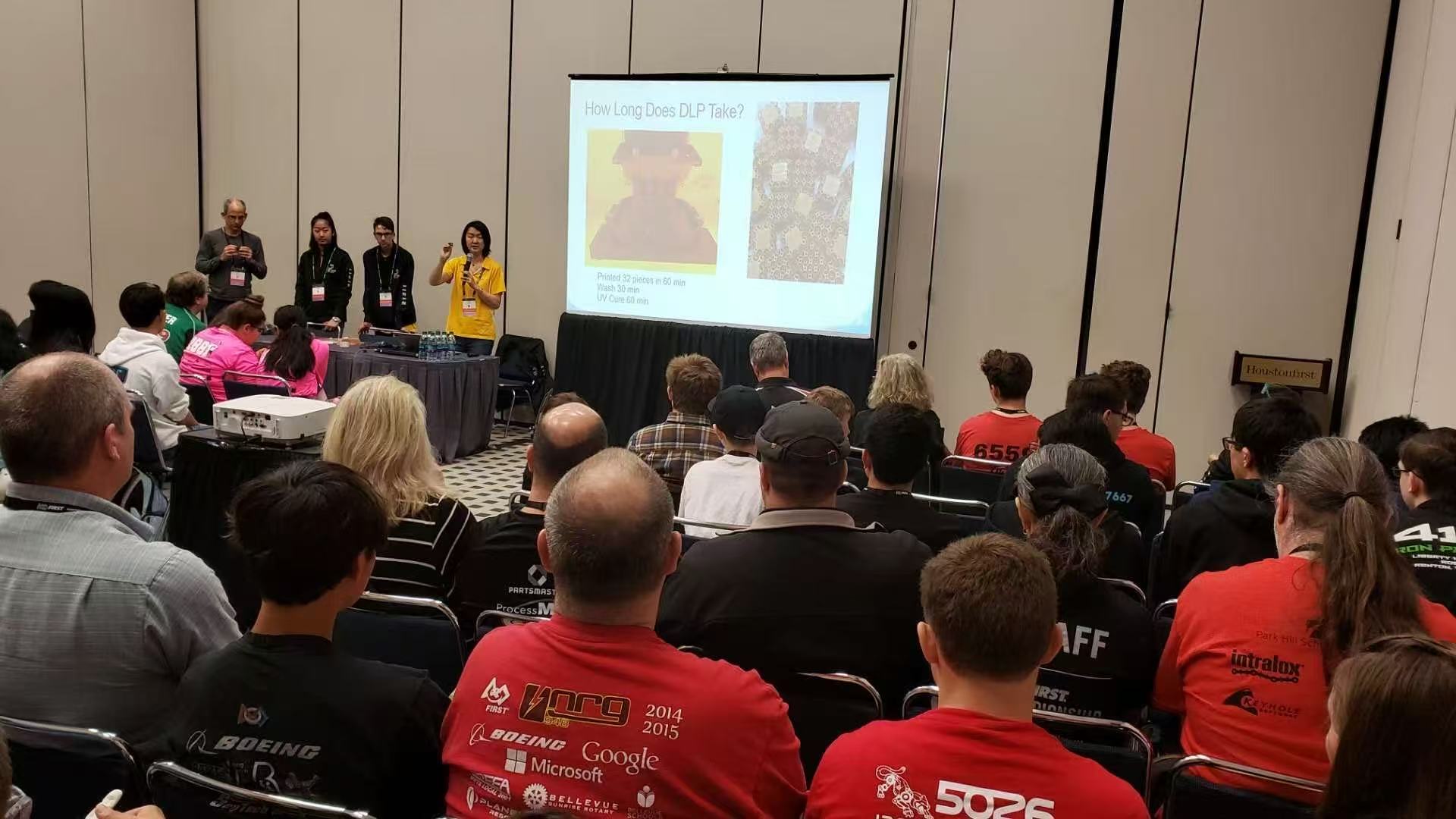Coach Olivia presenting 3D printing to a packed conference room